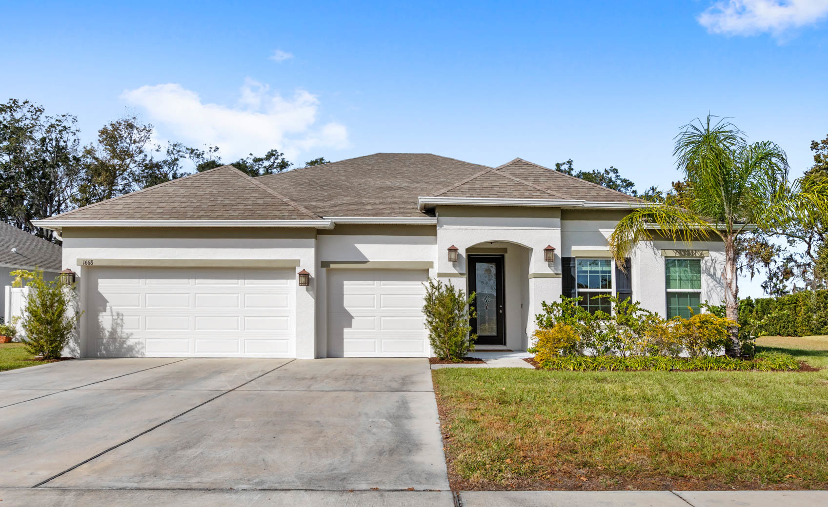 front of one story home with white paint and brown roof